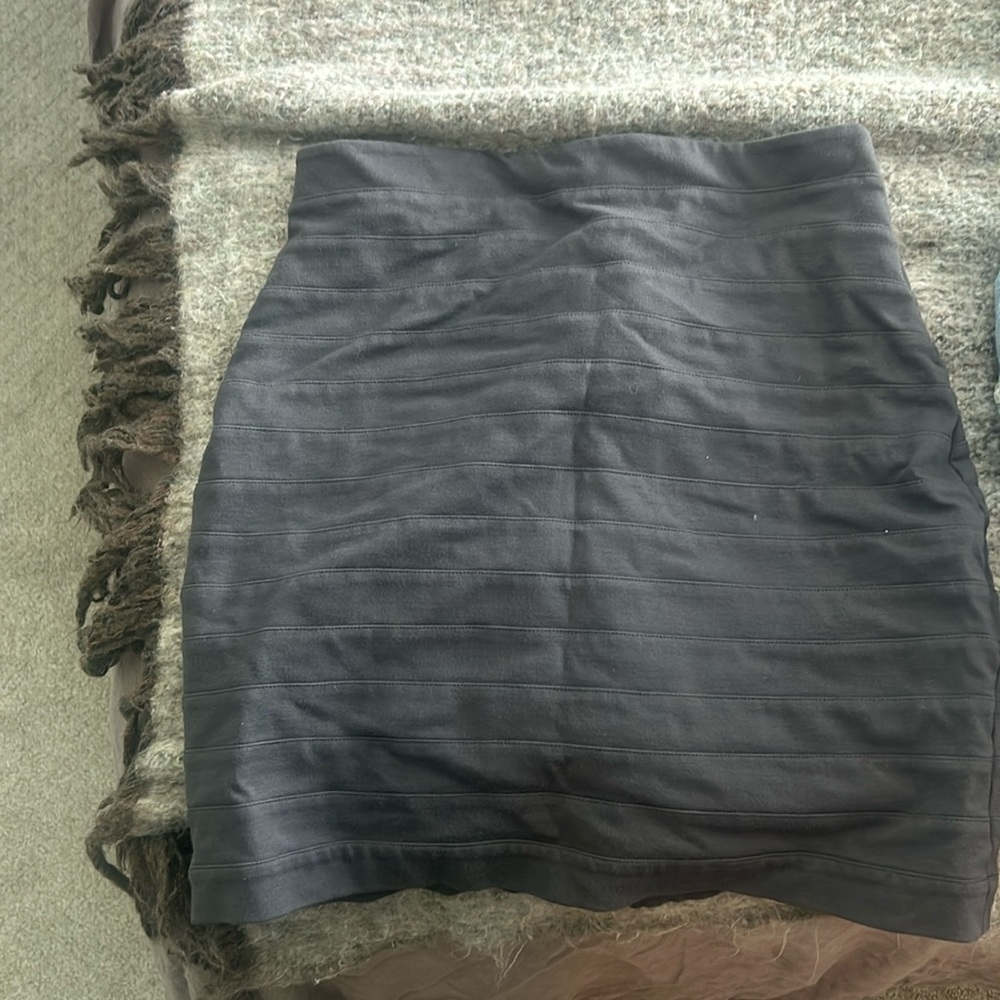 Ripped, tight, mid length grey skirt